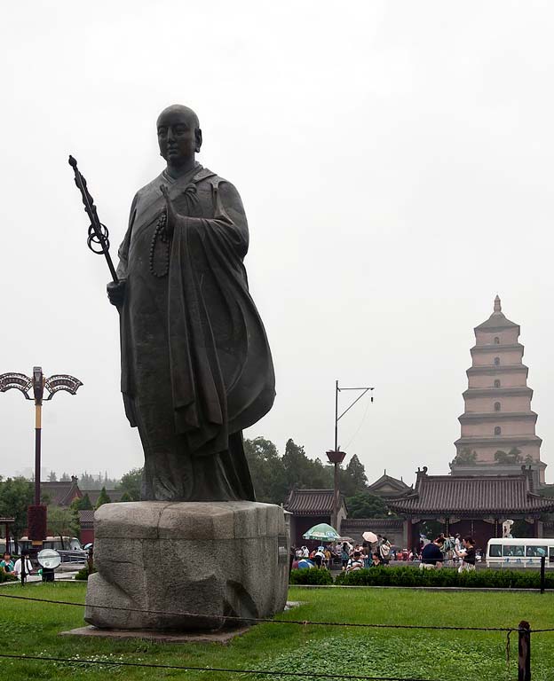 A statue of monk Xuanzang in front of the Giant Wild Goose Pagoda