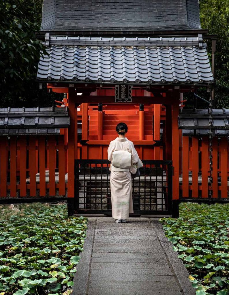 Woman in front of shrine